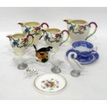 Four Royal Cauldon 'Victoria' pattern jugs in sizes, printed with flowers (the tallest 15cm high),