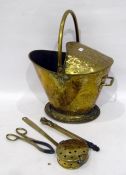 Antique brass embossed coal scuttle with half-hood, floral repousse and sundry tools