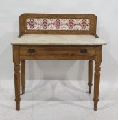 A 19th century tile-back washstand with rectangular marble top, single drawer to turned supports,
