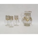 Late Victorian/Edwardian cut glass gilt jug faceted body floral and festoon decorated and three