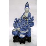 Chinese porcelain blue and white figure of a guanyin on a pierced wooden lotus leaf base,