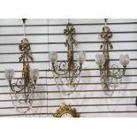 Three gilt metal and glass double-branch wall light brackets with ribbon and foliate decoration,