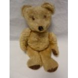 Small blonde straw stuffed bear with glass eyes and stitched nose and mouth 35cm