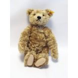 A Steiff plush bear with growler and a linen sailor jacket glass eyes and a stitched nose and