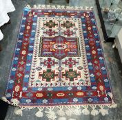 Modern Persian style rug with geometric decoration to a cream central ground, blue and red
