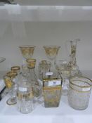 Gilt and clear liqueur ewer, scrolling foliate decorated, three matching stemmed liqueur glasses,