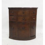 A late 19th century mahogany corner cabinet with six assorted drawers above three cupboard doors,