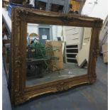A 20th century rectangular bevel edged wall mirror in moulded gilt gesso effect frame, 165cm x 132cm