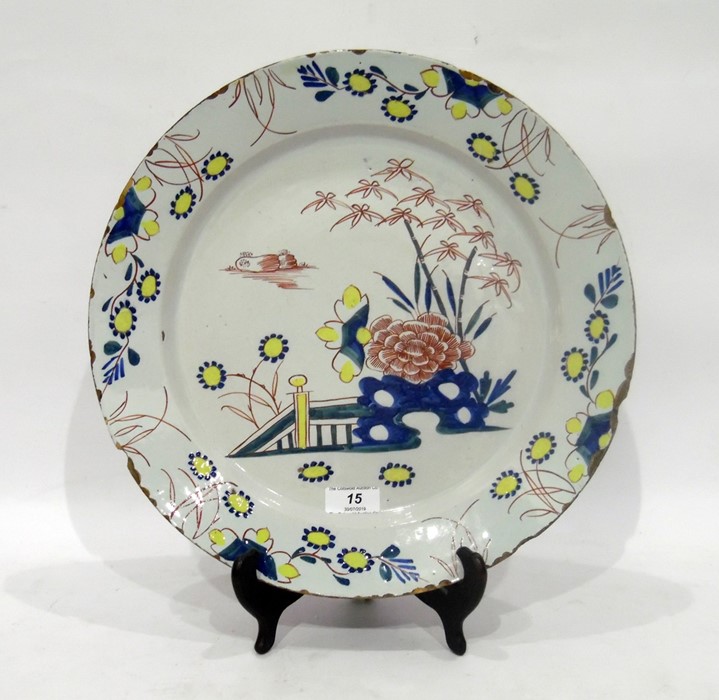 English delftware polychrome charger, circa 1750, probably London, painted with chrysanthemum and