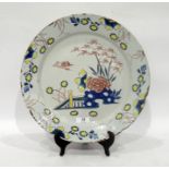 English delftware polychrome charger, circa 1750, probably London, painted with chrysanthemum and