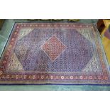 Large blue ground carpet with diamond-shaped red ground central medallion, allover foliate