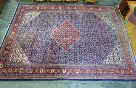 Large blue ground carpet with diamond-shaped red ground central medallion, allover foliate