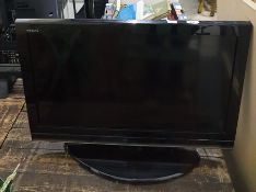 A Toshiba flatscreen television, 30" and a JVC video recorder and remote controls (2)