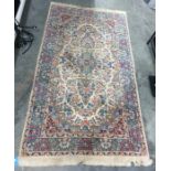 Cream ground Eastern rug with blue ground and stepped central medallion, allover foliate