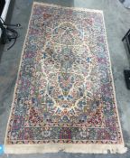 Cream ground Eastern rug with blue ground and stepped central medallion, allover foliate