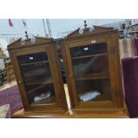 Pair of 20th century oak wall-hanging corner display cabinets, the broken arched pediment above