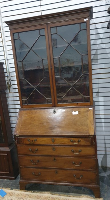 A 19th century mahogany bureau bookcase with ogee moulded pediment above astragal glazed doors,