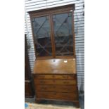 A 19th century mahogany bureau bookcase with ogee moulded pediment above astragal glazed doors,