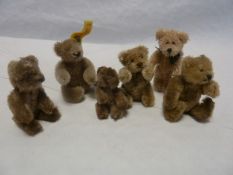 Steiff miniature teddy, seated 7cm high and five various jointed miniature gold plush teddies,