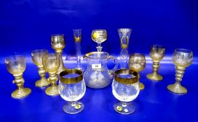 Eight various gilt tinted hock type wines with banded tapered stems and prunt decoration, a gilt