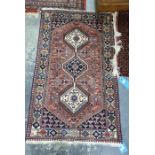 Reproduction Persian style wool rug with three hooked lozenge medallions in shades of blue, cream