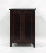 19th century mahogany two-door cabinet enclosing shelves, raised upon square section supports,