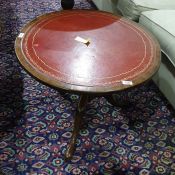 19th century mahogany circular centre table with red leather top, turned support to three cabriole
