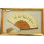 Painted silk and stamped wood fan, framed, pierced and stamped, with a silk tassel, depicting