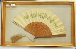 Painted silk and stamped wood fan, framed, pierced and stamped, with a silk tassel, depicting