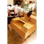 20th century G-Plan light oak dressing table with shaped mirror above two short and one long drawer,