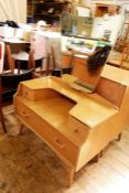 20th century G-Plan light oak dressing table with shaped mirror above two short and one long drawer,