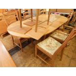 Light elm Ercol D-end extending dining table and six ladderback Ercol chairs with foliate