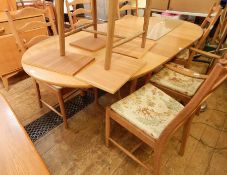 Light elm Ercol D-end extending dining table and six ladderback Ercol chairs with foliate