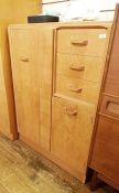 20th century G-Plan compactum in light oak, left hand wardrobe door and to the right three drawers