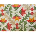Late 19th century American quilt in cream, green, red, blue and yellow 'tulip' pattern, described as