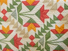 Late 19th century American quilt in cream, green, red, blue and yellow 'tulip' pattern, described as