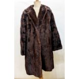 Two vintage fur coats, one being goatskin trimmed with mink, two faux-fur coats, a faux-fur shrug, a