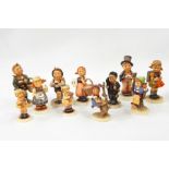 Eleven Goebel Hummel figures of children, incl. boy in top hat, girl with embroidery (af) (11)