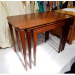 20th century teak nest of three coffee tables, the rectangular tops with indented corners, on square