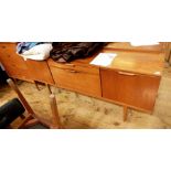 Austinsuite teak sideboard with central drawer and drop down cocktail cabinet, flanked by pair