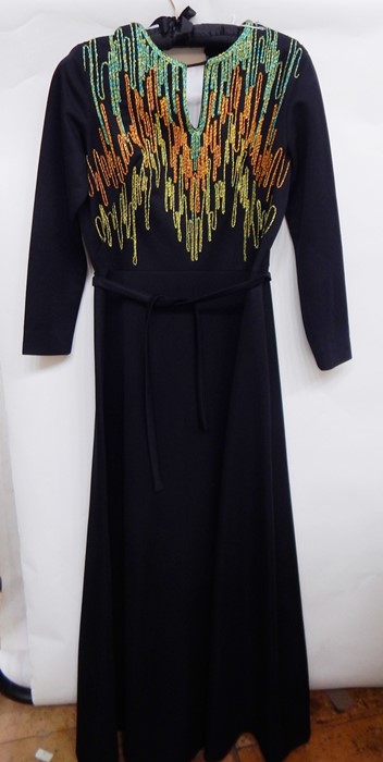 Black 1970's maxi dress labelled Carnegie, with neon embroidered detail to the bodice,