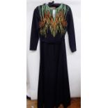 Black 1970's maxi dress labelled Carnegie, with neon embroidered detail to the bodice,
