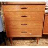 Pair of mid 20th century teak four-drawer chests with bar handles, on cylindrical tapering supports,