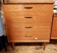 Pair of mid 20th century teak four-drawer chests with bar handles, on cylindrical tapering supports,