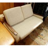 Mid 20th century sofabed finished in a light blue upholstery, hardwood arm rests and raised upon