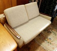 Mid 20th century sofabed finished in a light blue upholstery, hardwood arm rests and raised upon