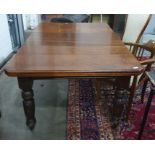 Victorian extending dining table on turned supports to castors 147 x 101 cms, extended