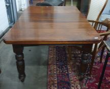 Victorian extending dining table on turned supports to castors 147 x 101 cms, extended