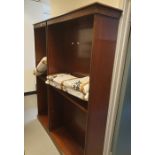 A 20th century mahogany open bookcase raised upon plinth base and one further similar