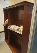 A 20th century mahogany open bookcase raised upon plinth base and one further similar